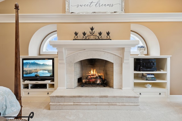 interior details with carpet flooring and a tile fireplace