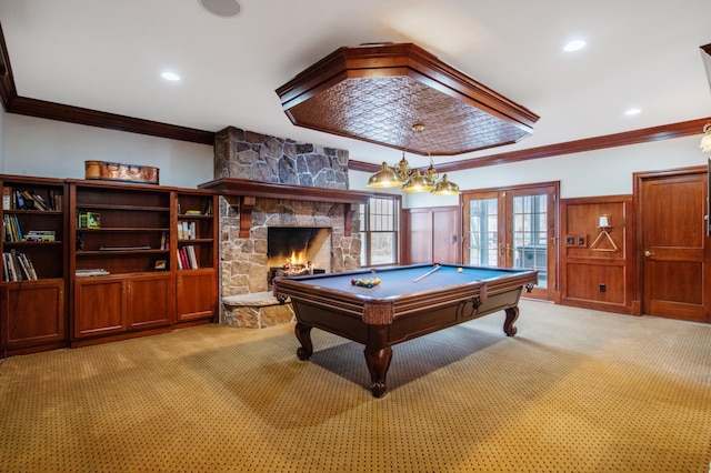 playroom with french doors, light colored carpet, ornamental molding, and a fireplace