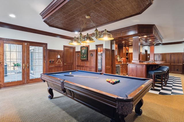 rec room with light carpet, a wainscoted wall, and crown molding