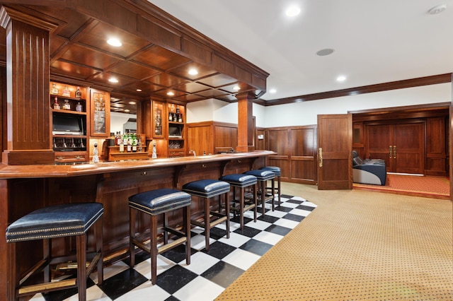 bar with wainscoting, recessed lighting, wet bar, and ornamental molding