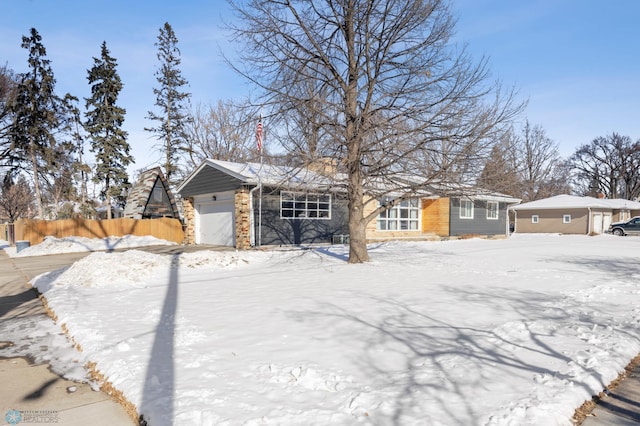 view of front of property with fence and an attached garage