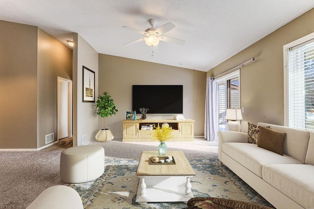 carpeted living area featuring visible vents, a textured ceiling, a ceiling fan, and vaulted ceiling