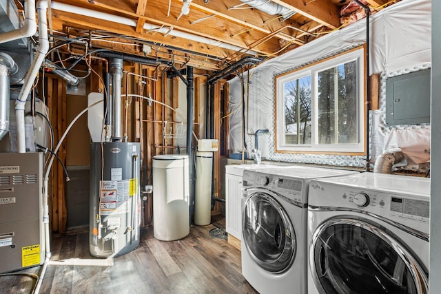 laundry area with wood finished floors, gas water heater, washing machine and clothes dryer, and laundry area