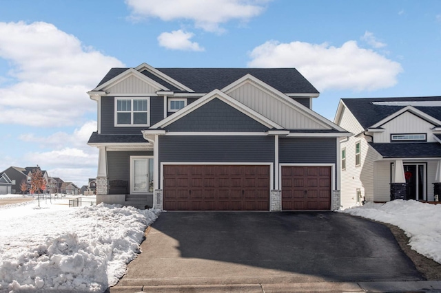 craftsman-style house featuring an attached garage, board and batten siding, and driveway