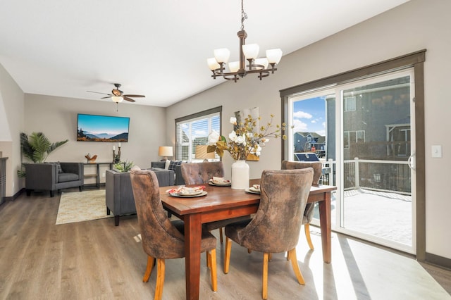 dining room featuring baseboards, ceiling fan with notable chandelier, and light wood finished floors