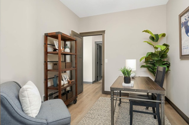 office area with baseboards and light wood-type flooring