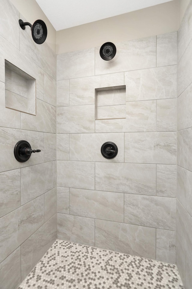 full bath featuring a tile shower