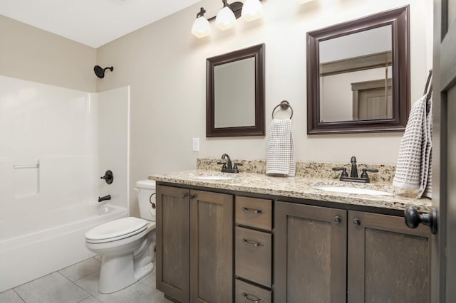 full bath featuring a sink, toilet, double vanity, and tile patterned flooring