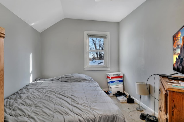 bedroom with lofted ceiling, carpet flooring, and baseboards