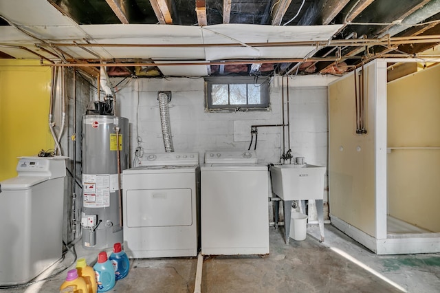 laundry room featuring a sink, laundry area, gas water heater, and washing machine and clothes dryer