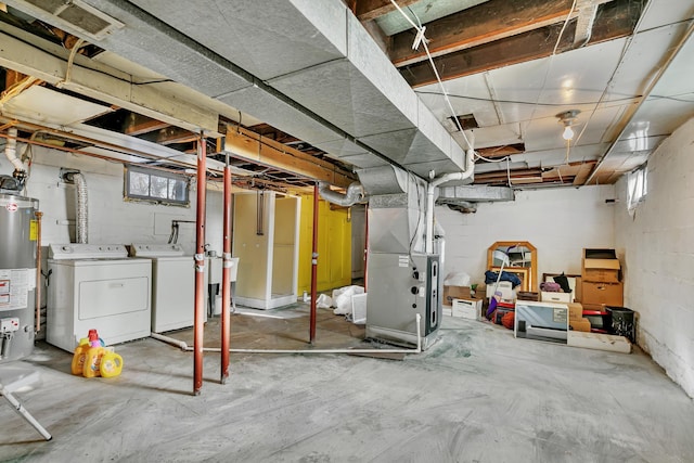 below grade area featuring gas water heater, heating unit, and washer and dryer