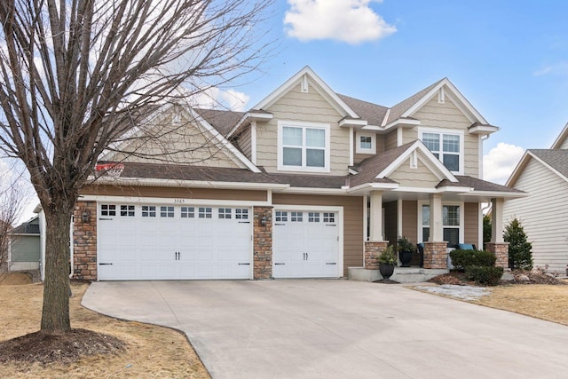 craftsman house with an attached garage, driveway, roof with shingles, and stone siding