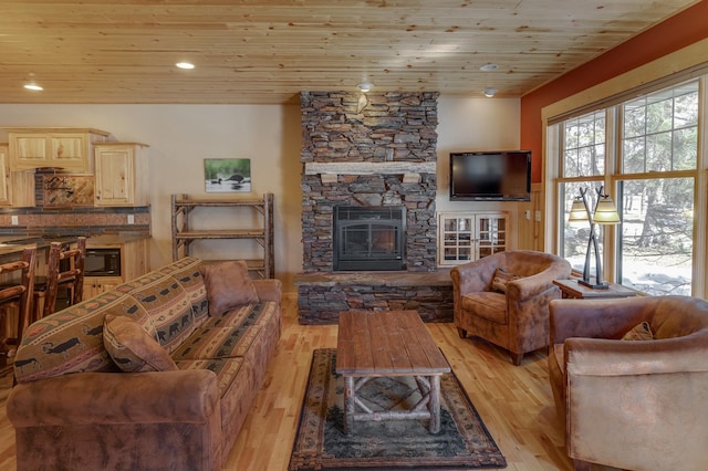 living area with light wood-style floors, wood ceiling, a fireplace, and recessed lighting