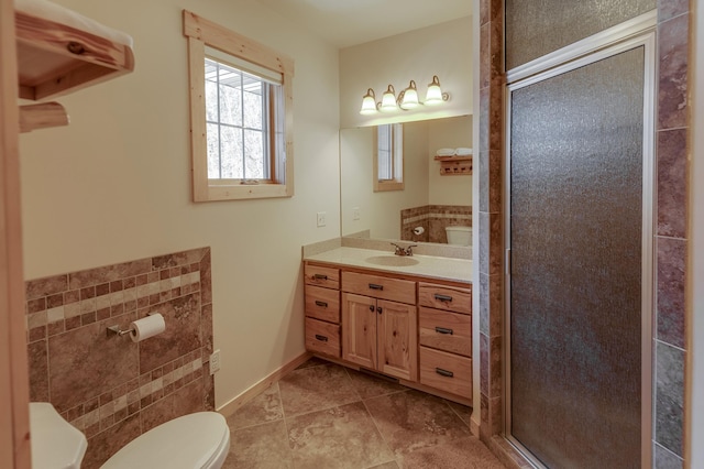 full bath featuring toilet, a shower stall, baseboards, and vanity