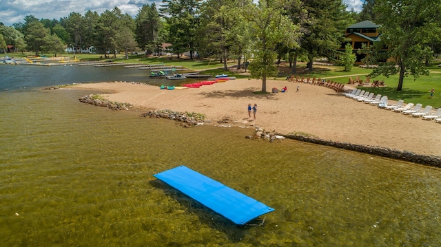 view of property's community featuring a water view and a lawn