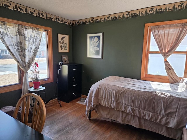 bedroom featuring a textured ceiling and wood finished floors