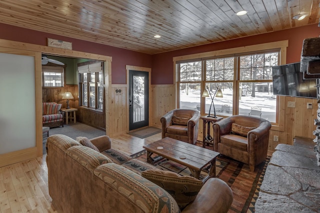 living room with recessed lighting, wainscoting, wood ceiling, and light wood-style floors