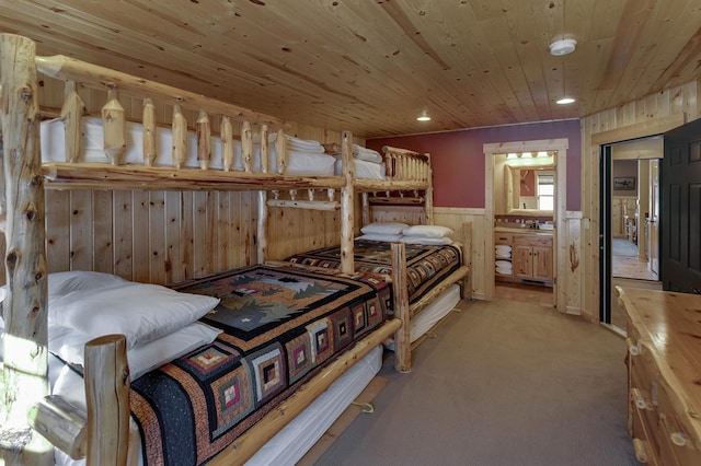 bedroom with wooden ceiling, recessed lighting, a wainscoted wall, light carpet, and wooden walls