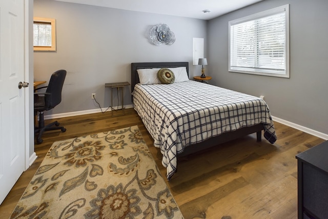 bedroom featuring baseboards and wood finished floors