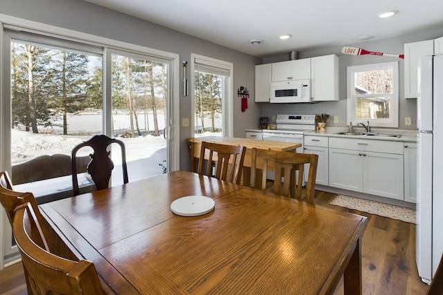 dining area featuring dark wood-style flooring and recessed lighting