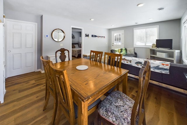 dining room with baseboards, wood finished floors, and recessed lighting