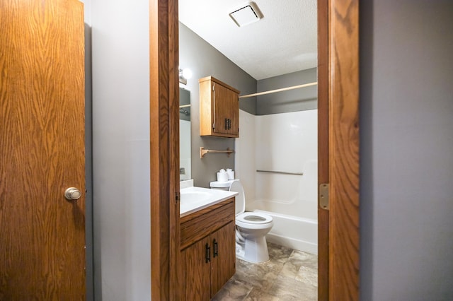 full bath featuring visible vents, toilet, shower / tub combination, a textured ceiling, and vanity