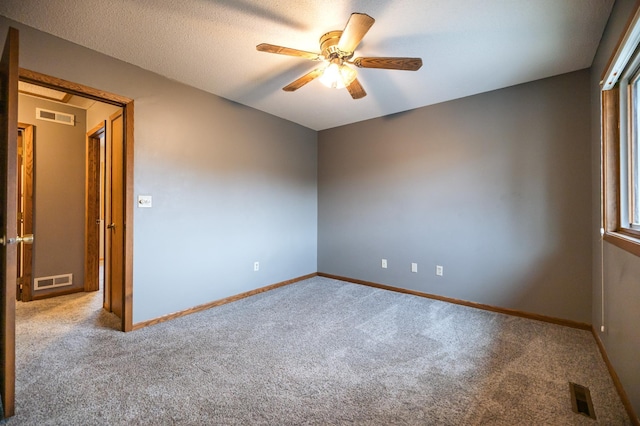 unfurnished room featuring baseboards, visible vents, and a ceiling fan