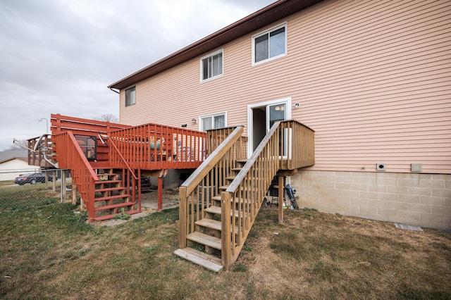 back of property with a yard, stairway, and a wooden deck