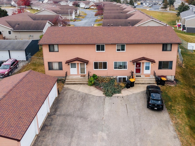 view of front of property with roof with shingles, a residential view, and an outbuilding