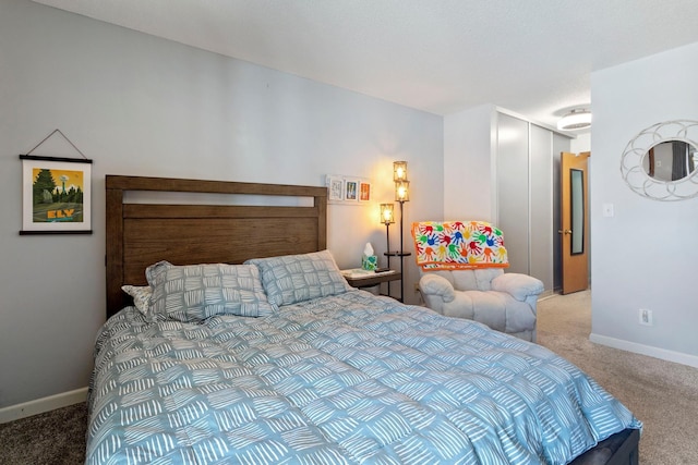 bedroom featuring a closet, light colored carpet, and baseboards