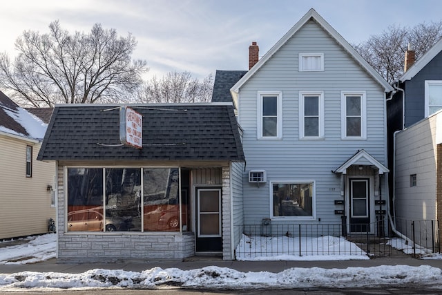 view of front of property with roof with shingles