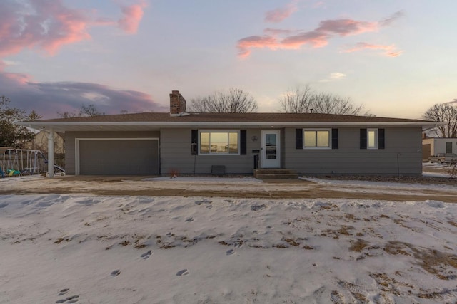 single story home featuring an attached garage and a chimney