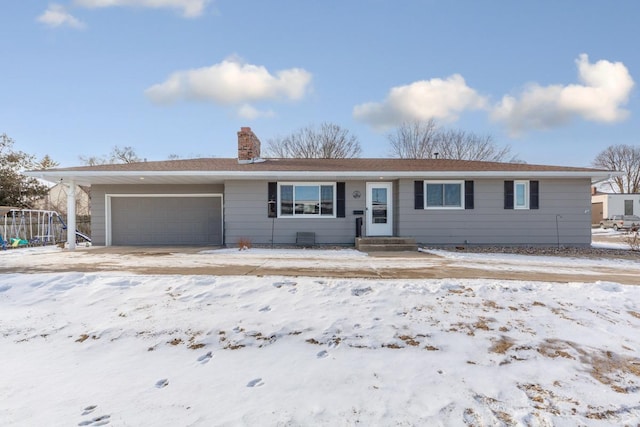 ranch-style house featuring a chimney and an attached garage