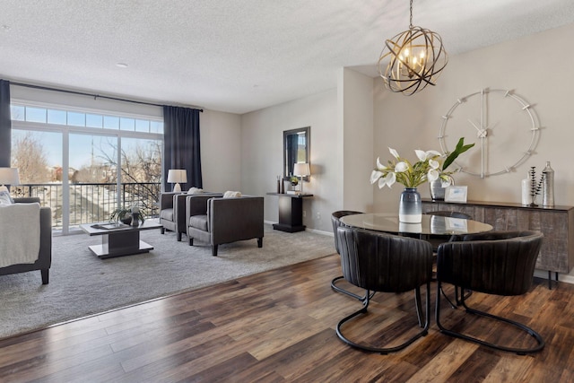 living room with a notable chandelier, a textured ceiling, and wood finished floors