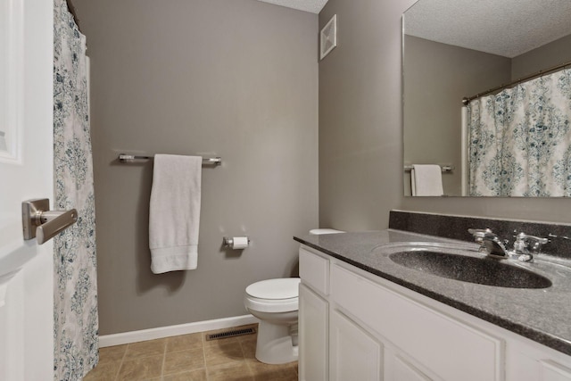 bathroom featuring toilet, visible vents, a textured ceiling, and vanity