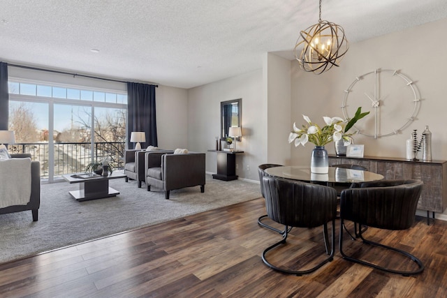 living area featuring a notable chandelier, a textured ceiling, and wood finished floors