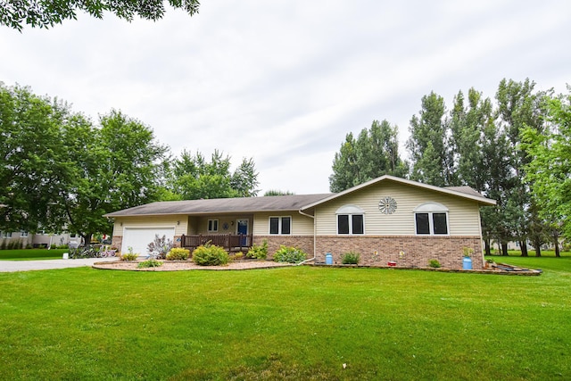 single story home featuring a garage, driveway, brick siding, and a front lawn