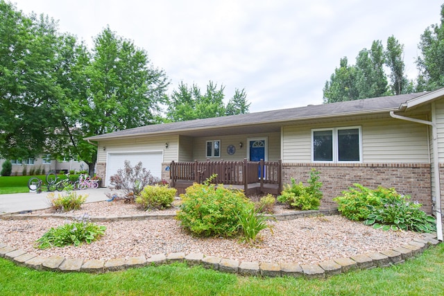 ranch-style home with covered porch, concrete driveway, brick siding, and an attached garage