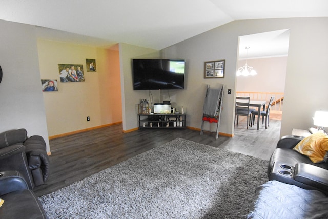 living room with a notable chandelier, vaulted ceiling, baseboards, and wood finished floors