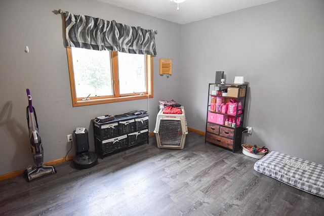 rec room with baseboards and wood finished floors