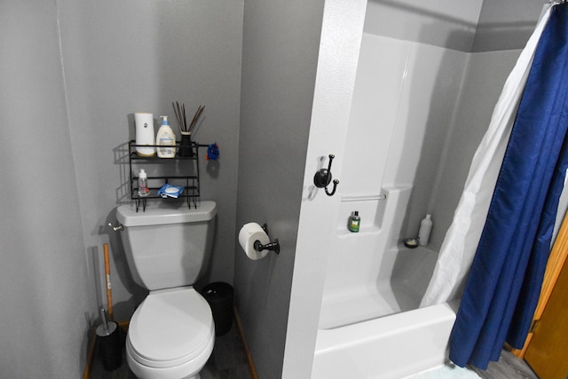 full bathroom with toilet and a shower with shower curtain