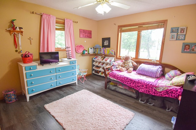 bedroom with dark wood-style flooring, a ceiling fan, and baseboards