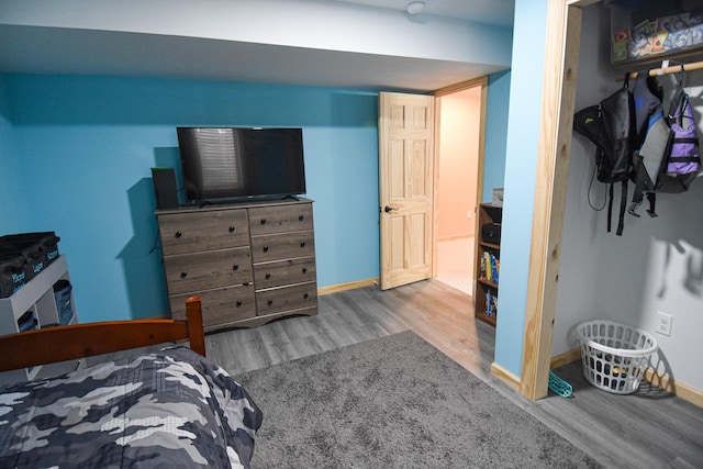 bedroom with wood finished floors and baseboards