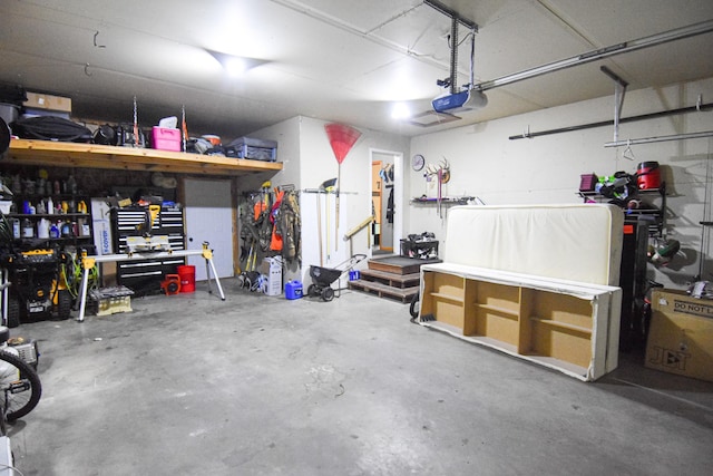 garage with a workshop area and a garage door opener