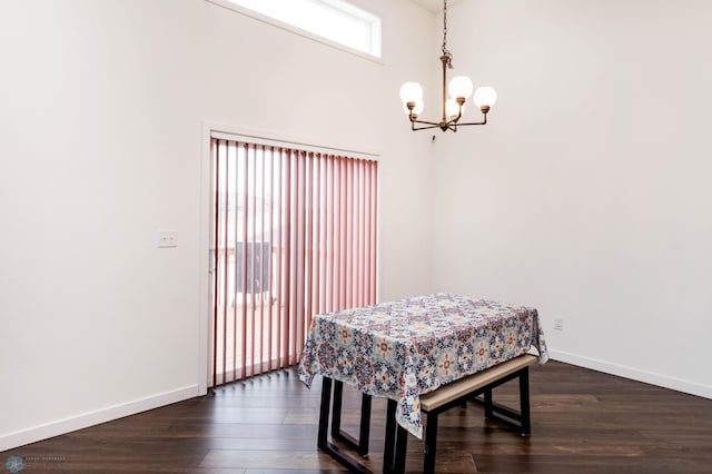 dining room with dark wood-style floors, a notable chandelier, and baseboards