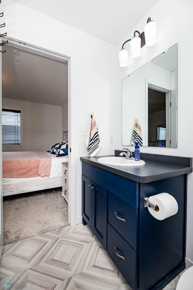 bathroom featuring ensuite bathroom and vanity