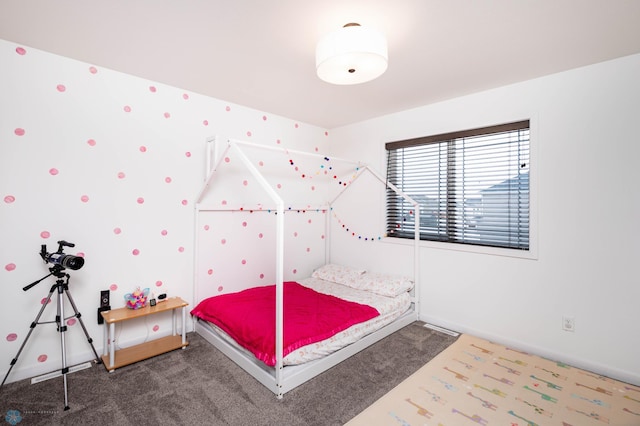 carpeted bedroom featuring baseboards