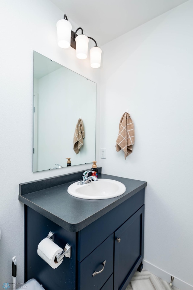 bathroom with vanity and baseboards