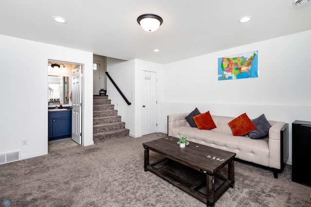 living area with carpet floors, recessed lighting, visible vents, stairway, and baseboards