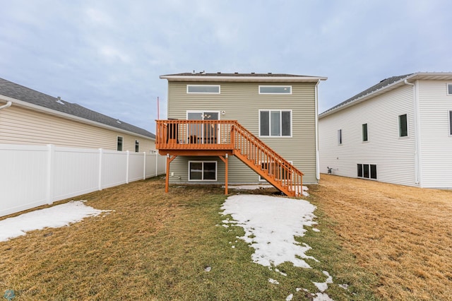 rear view of house with stairway, fence, a deck, and a yard